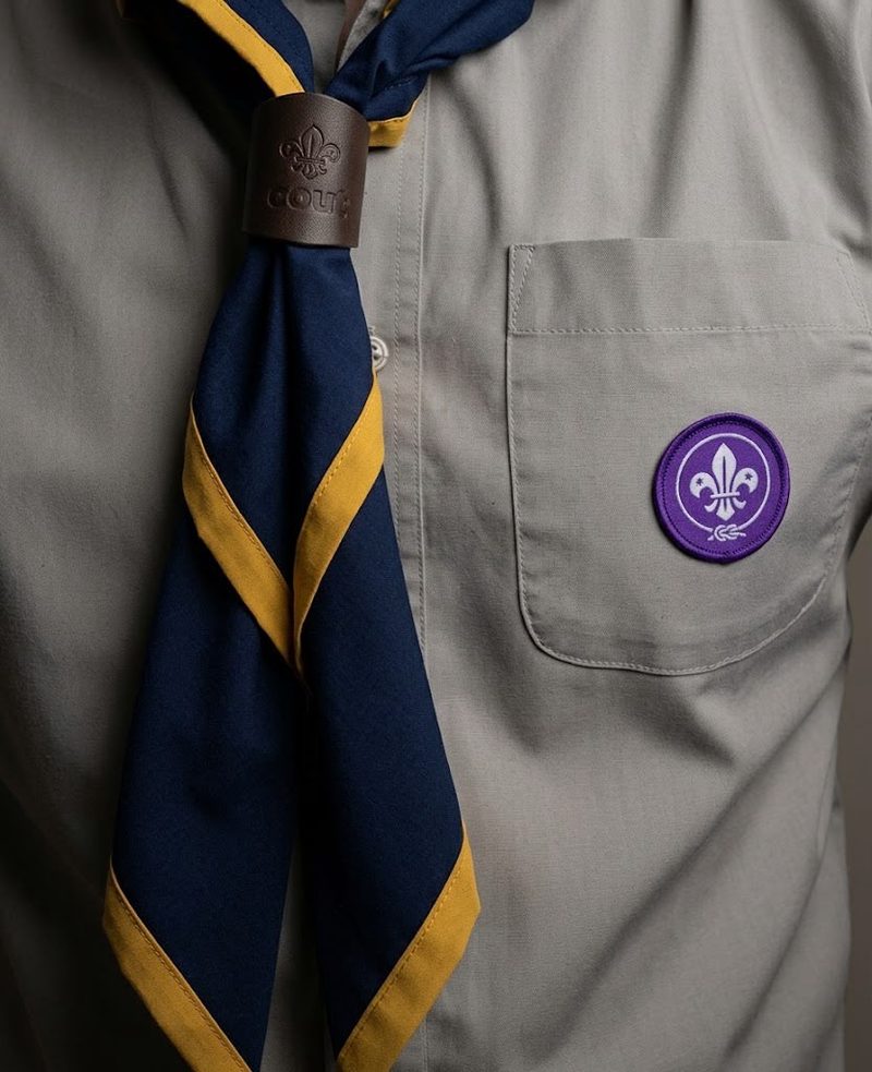 1st Brabazon group necker – navy with a gold diagonal stripe, worn with the grey Scouts shirt